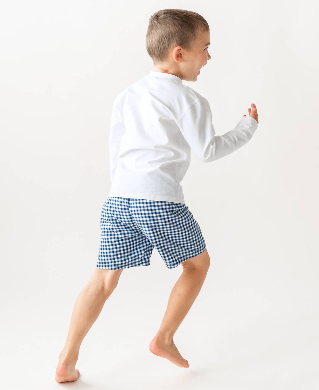 RuffleButts - Navy Gingham Swim Trunks