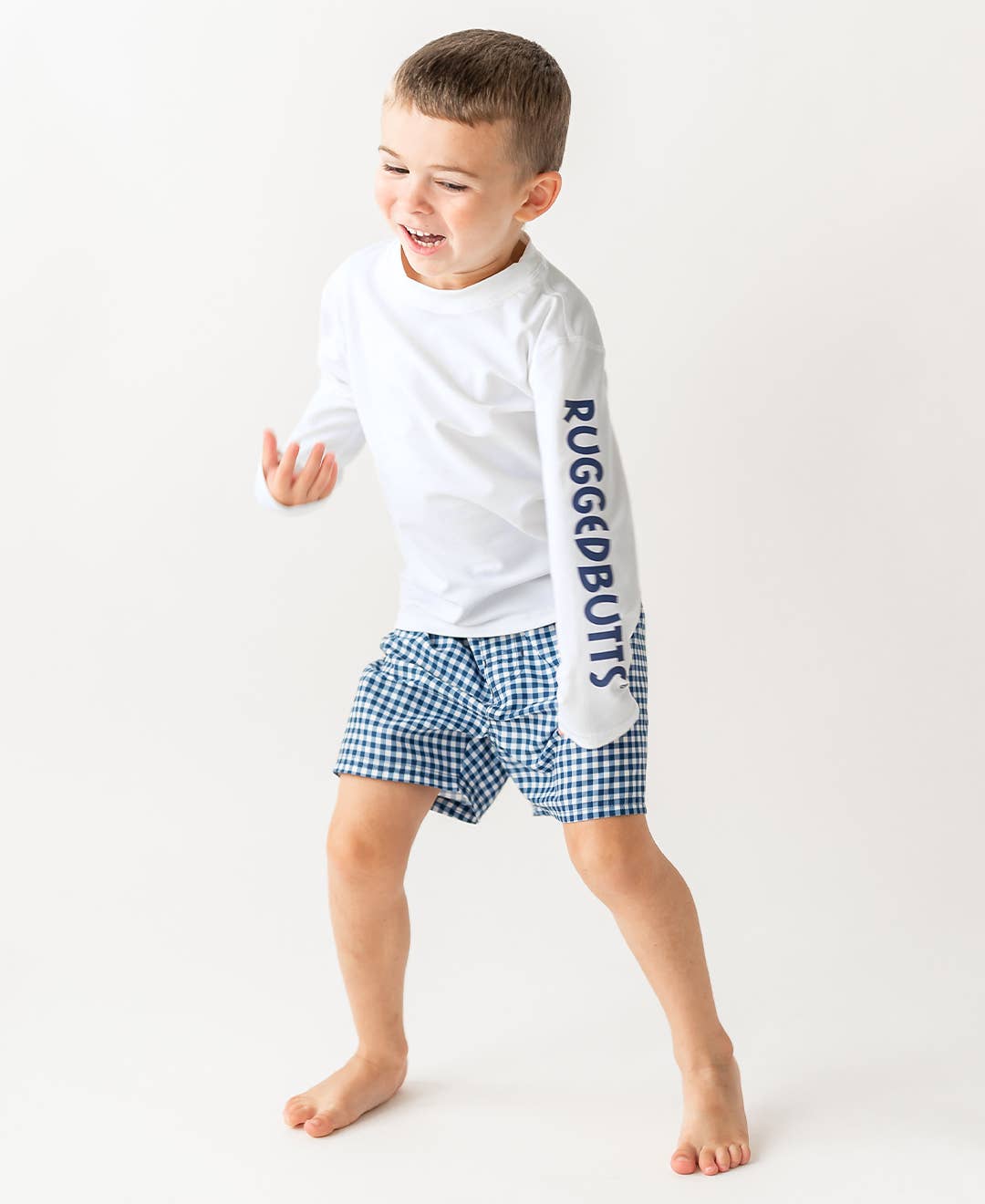 RuffleButts - Navy Gingham Swim Trunks