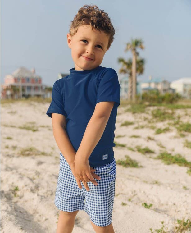 RuffleButts - Navy Gingham Swim Trunks